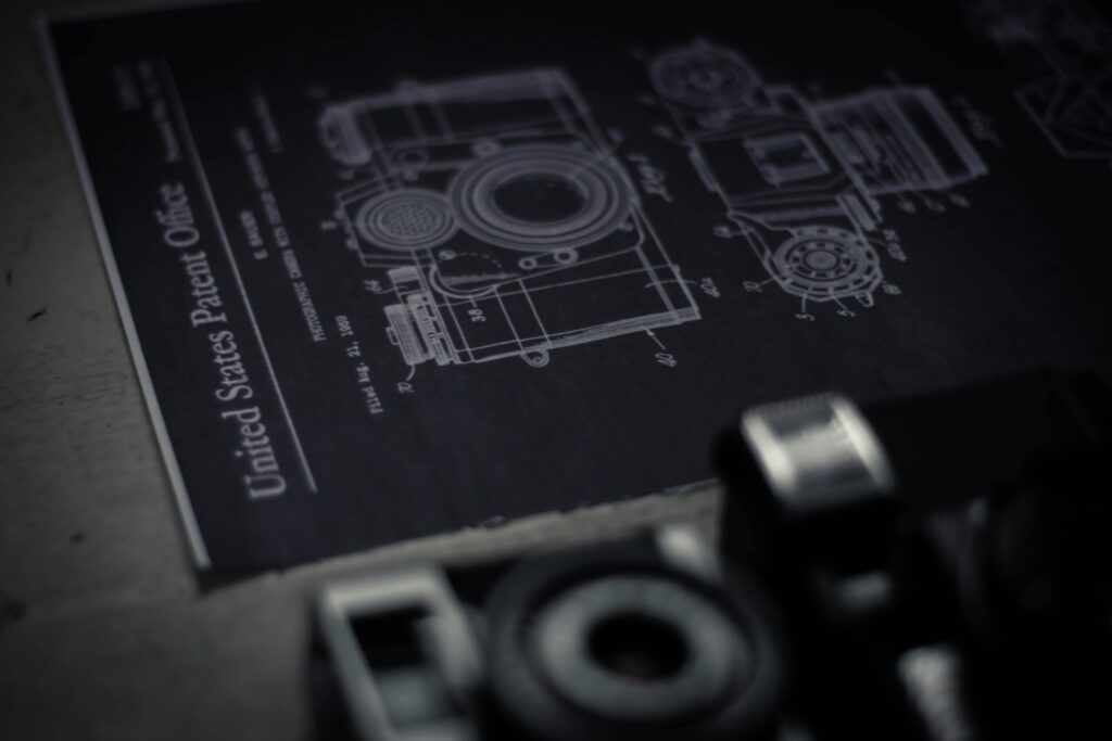 pexels-photo-4172287-4172287 Detailed blueprint of a camera with an official patent from the United States Patent Office.