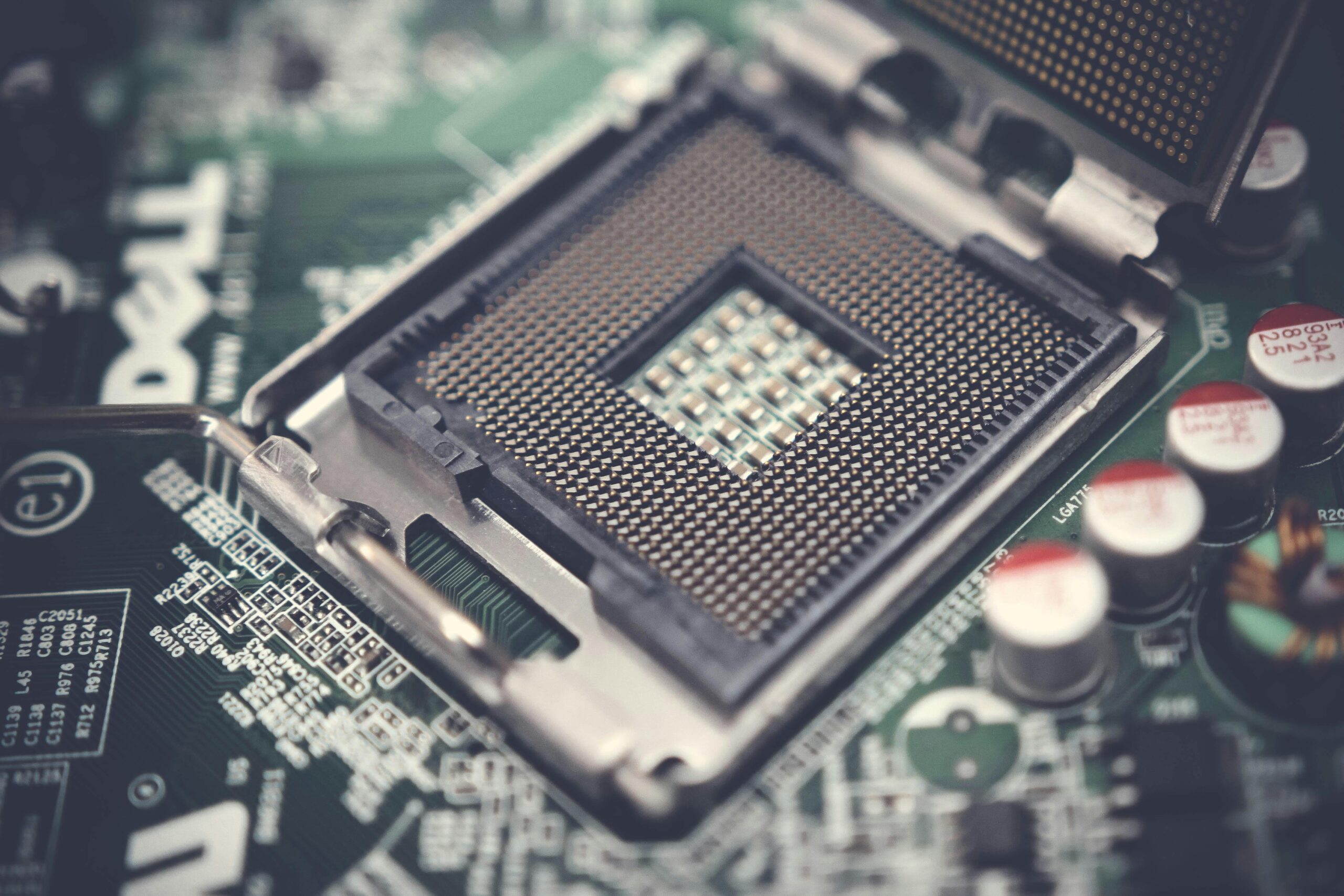 Detailed view of a CPU socket on a circuit board, highlighting electronic components.