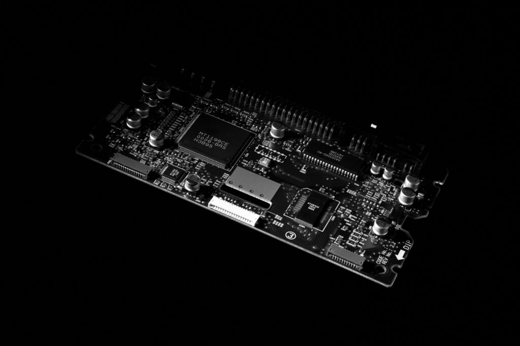 pexels-photo-3520679-3520679 Detailed black and white image of a computer circuit board, showcasing technology components.