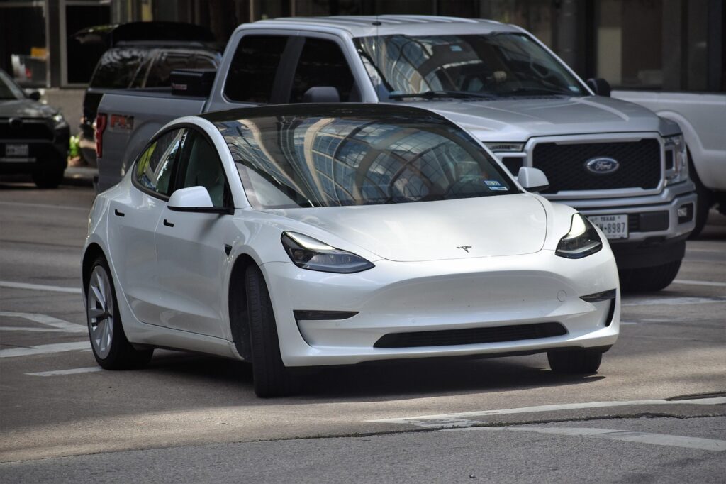 tesla, electric car, vehicle, future, technology, energy efficient, cars, traffic, downtown houston, houston texas, white, lifestyle, off road vehicle, pick up truck, sedan, road, intersection, street, new 2023-2024 car photographer, fresh, saving energy, alternative source, ev, 2025