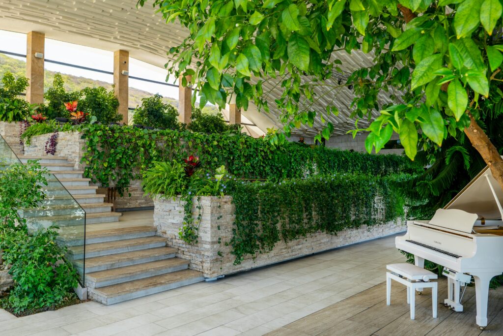 Elegant indoor garden with piano, showcasing modern green architecture in Tbilisi, Georgia.