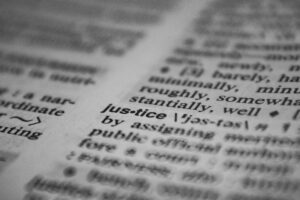 Selective focus close-up of the word justice in a dictionary, emphasizing concept clarity.